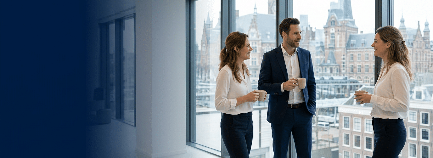 Premium hero banner. Three Caucasian professionals in business attire having an informal standing coffee meeting near a window in a bright modern Dutch office, relaxed and smiling, floor-to-ceiling wi (1)